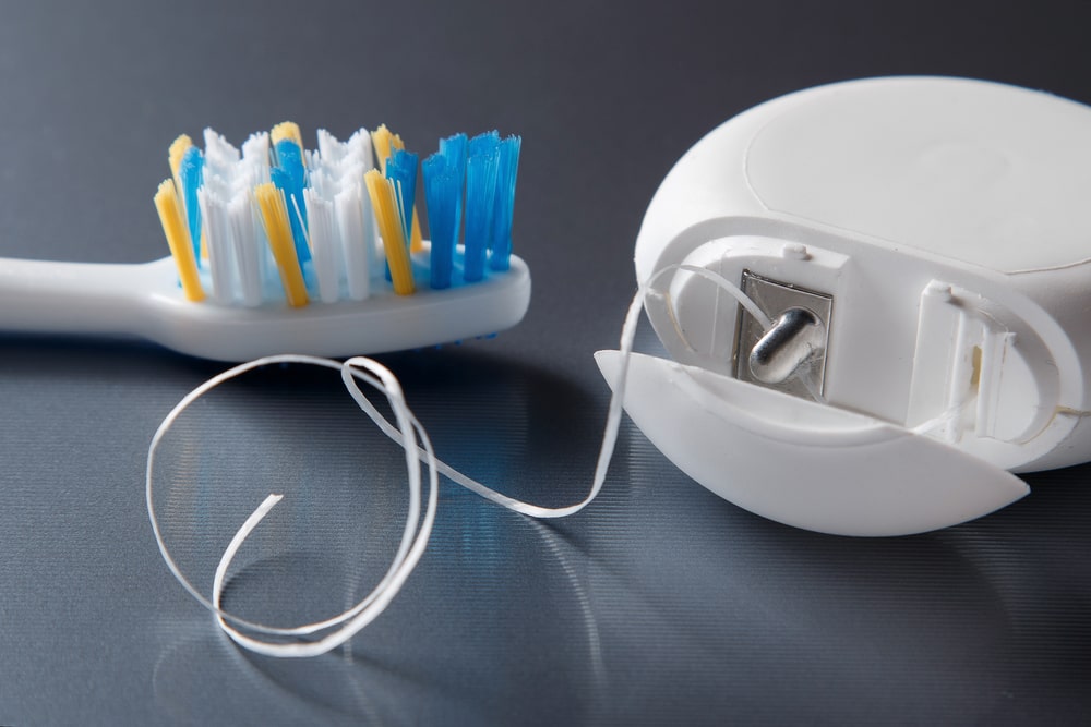 Close up of toothbrush and dental floss